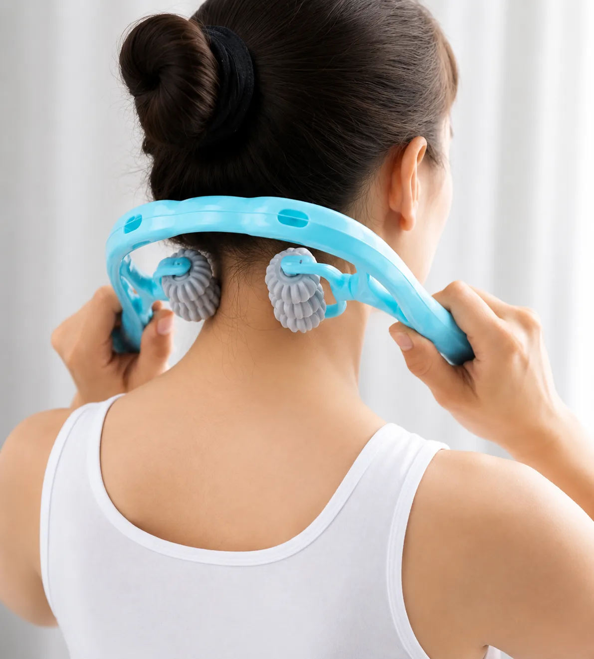 The massager hooked behind a model's neck, a column of rollers resting either side of the spine